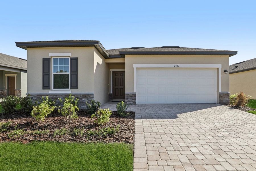 Front exterior of a new home in Hawks Run, Kissimmee, FL, highlighting curb appeal (Image 1).