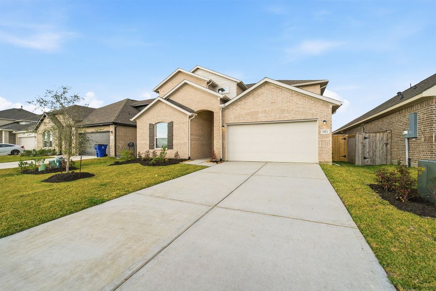 Front exterior of a new home in Windrose Green, Angleton, TX, highlighting curb appeal (Image 2).