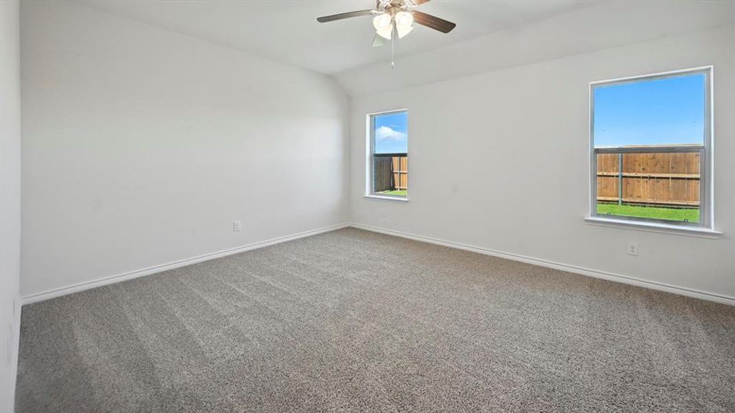 Expansive room with neutral carpet flooring and white baseboards Expansive room with neutral carpet flooring and white baseboards