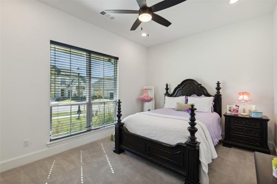 Carpeted bedroom with ceiling fan