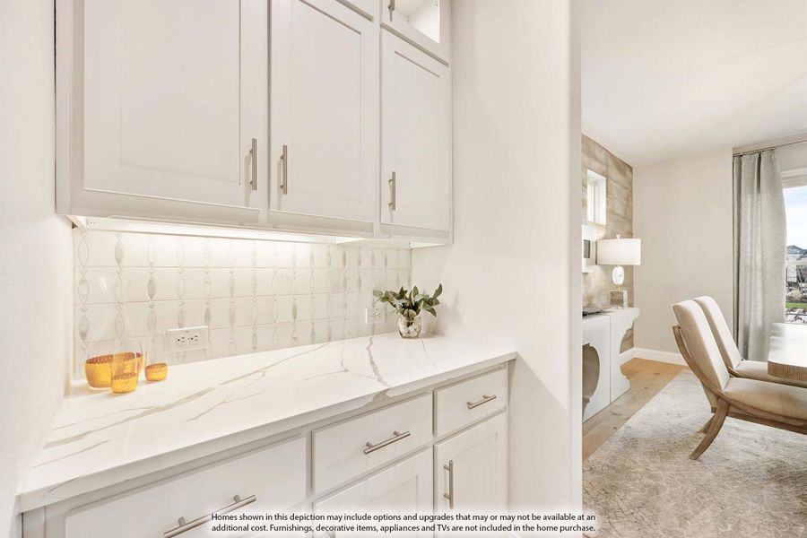 Butler's pantry with white shaker cabinets, marble countertop, and decorative tile backsplash with under-cabinet lighting