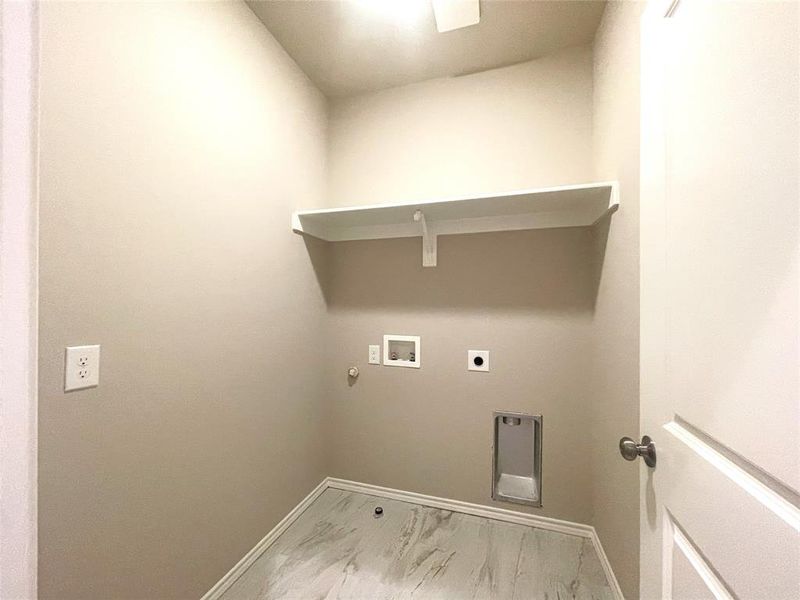 Laundry area with washer hookup, baseboards, hookup for an electric dryer, light marble finish floors, and gas dryer hookup