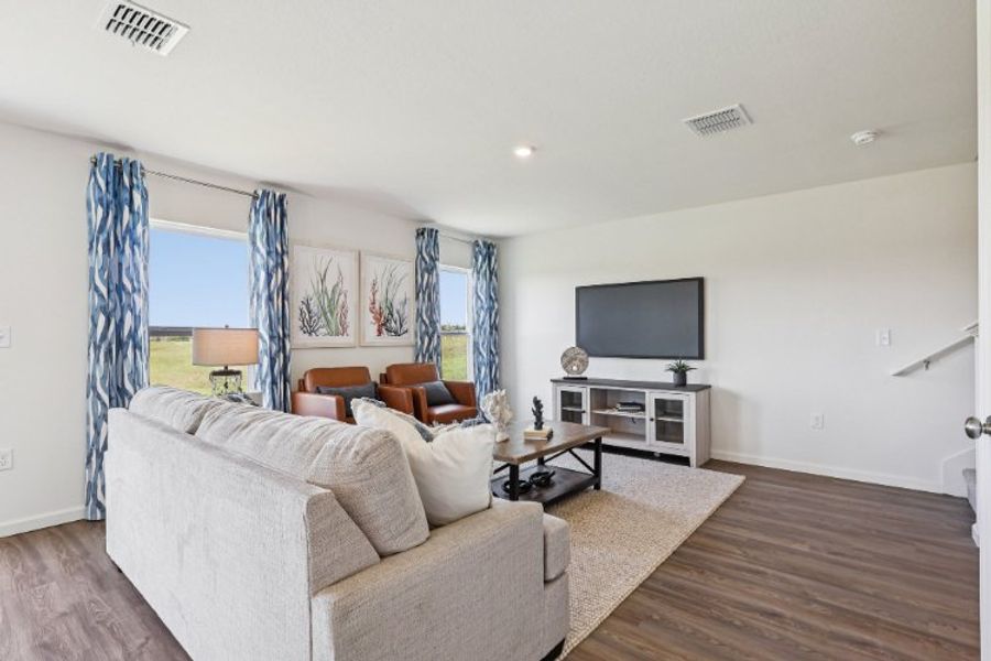 A living room with a tv and couches.