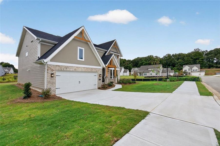Front exterior of a new home in Hidden Fields, Hoschton, GA, highlighting curb appeal (Image 18). Front exterior of a new home in Hidden Fields, Hoschton, GA, highlighting curb appeal (Image 18).