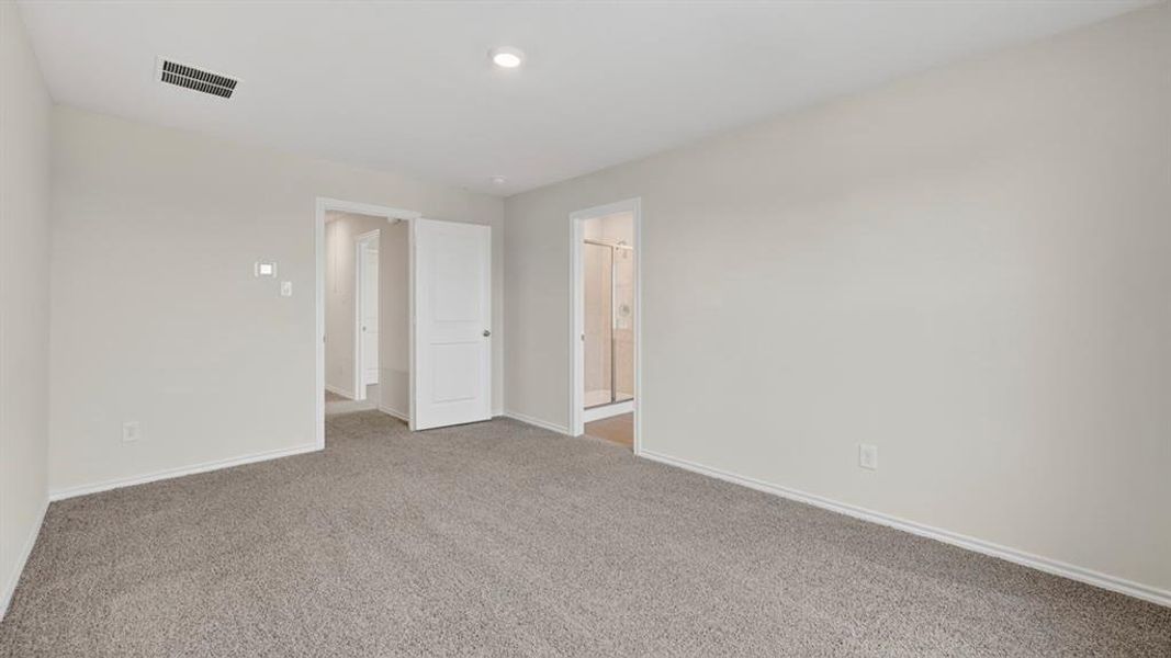 Spacious room featuring light gray walls, gray carpeting, and white trim