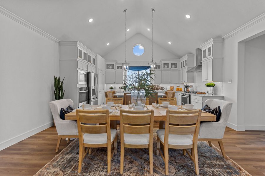 Dining area and kitchen with vaulted ceiling
