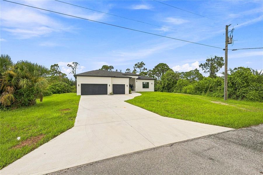 Front exterior of a new home in , Port Charlotte, FL, highlighting curb appeal (Image 26). Front exterior of a new home in , Port Charlotte, FL, highlighting curb appeal (Image 26).