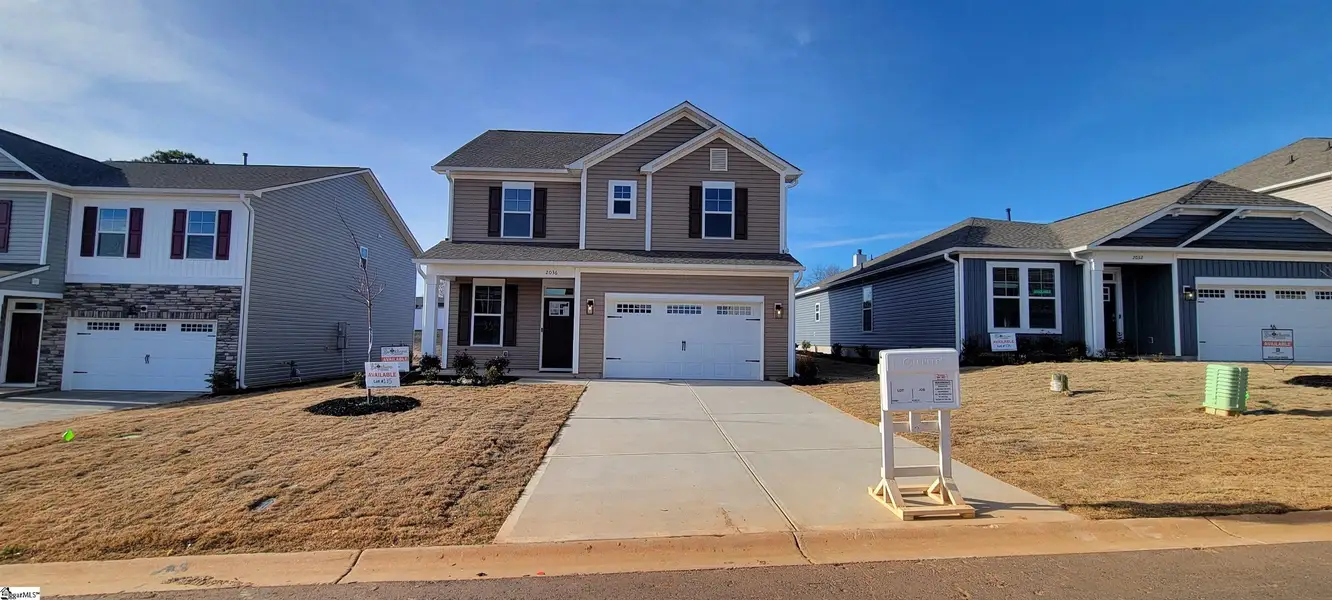 Front exterior of a new home in Halton Oaks, Spartanburg, SC, highlighting curb appeal (Image 1). Front exterior of a new home in Halton Oaks, Spartanburg, SC, highlighting curb appeal (Image 1).