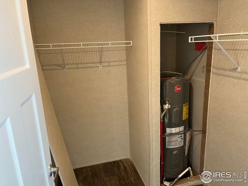 Walk in closet with water heater storage