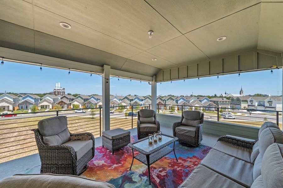 An elevated covered balcony provides sweeping views of the surrounding neighborhood. An elevated covered balcony provides sweeping views of the surrounding neighborhood.
