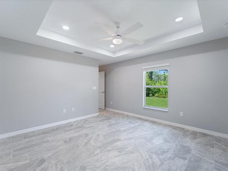 Primary bedroom has plenty of lighting