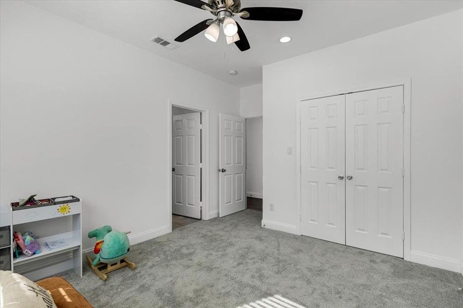 Bedroom featuring carpet, ceiling fan, a closet, and recessed lighting Bedroom featuring carpet, ceiling fan, a closet, and recessed lighting