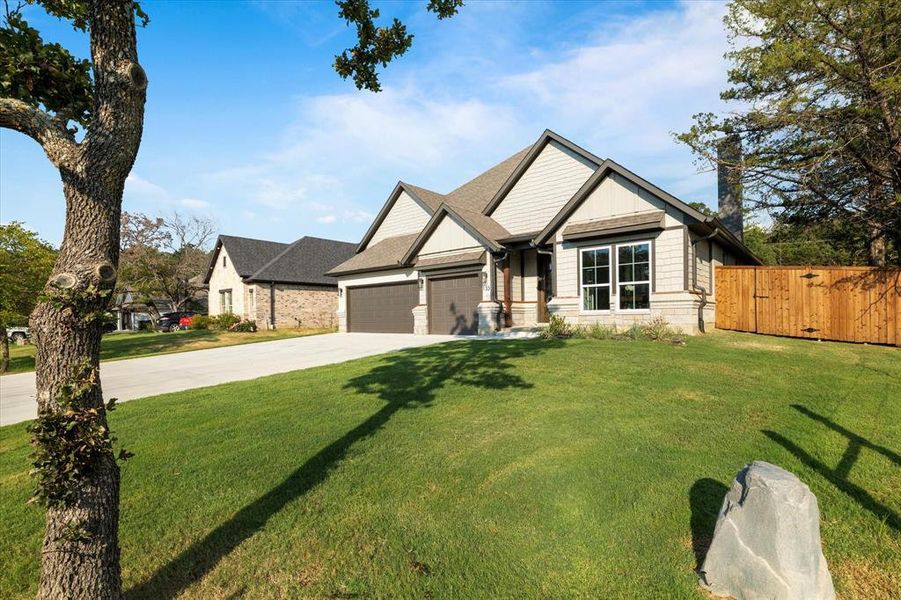 Craftsman inspired home with a garage and a front lawn Craftsman inspired home with a garage and a front lawn