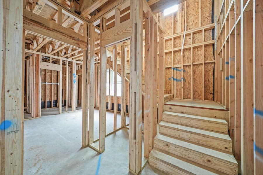 This is the stairwell leading to the second floor with the first floor bedroom with an ensuite bath to the left. This is the stairwell leading to the second floor with the first floor bedroom with an ensuite bath to the left.