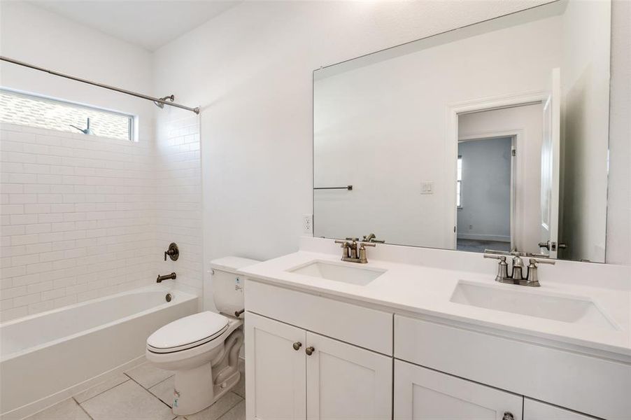 Full bath with light tile patterned flooring, shower / tub combination, and double vanity Full bath with light tile patterned flooring, shower / tub combination, and double vanity
