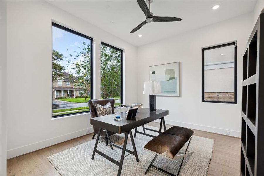 This exquisite office will accommodate your large office furniture and boasts Andersen picture windows overlooking the front of the home, white oak wood floors, thick baseboards, recessed lighting and a modern ceiling fan.