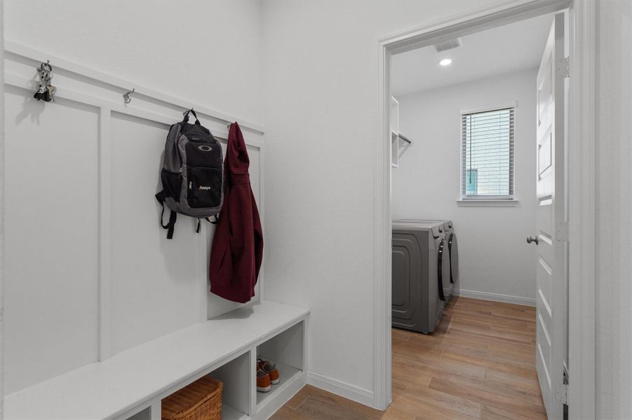Mudroom with light wood-style floors, separate washer and dryer, and recessed lighting