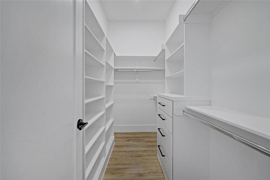 Walk-in closet for the primary bedroom. Walk-in closet for the primary bedroom.
