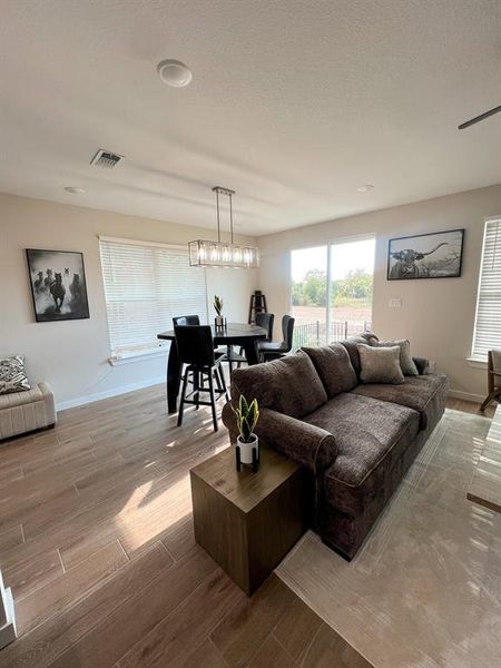 Living room featuring light wood-type flooring and baseboards