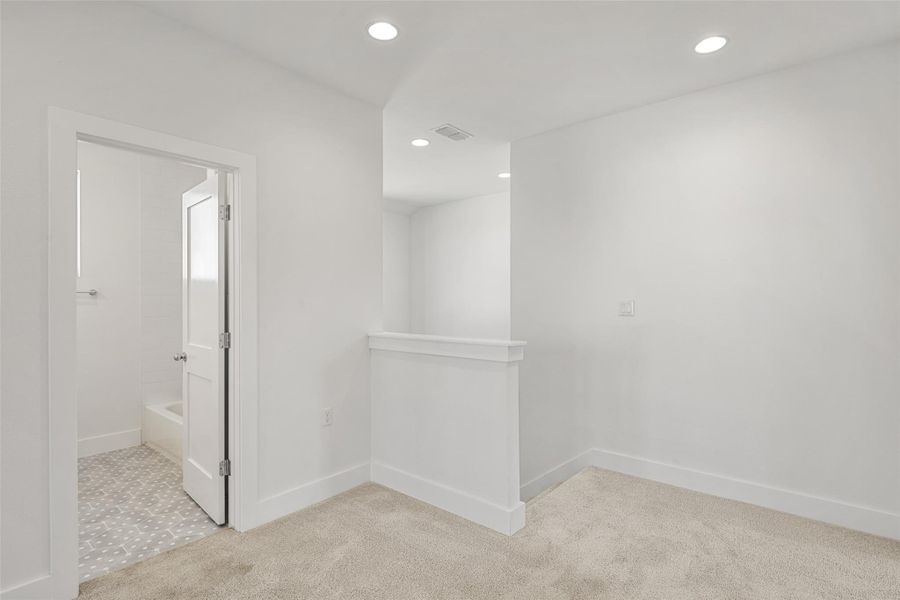 Unfurnished room with light carpet and recessed lighting