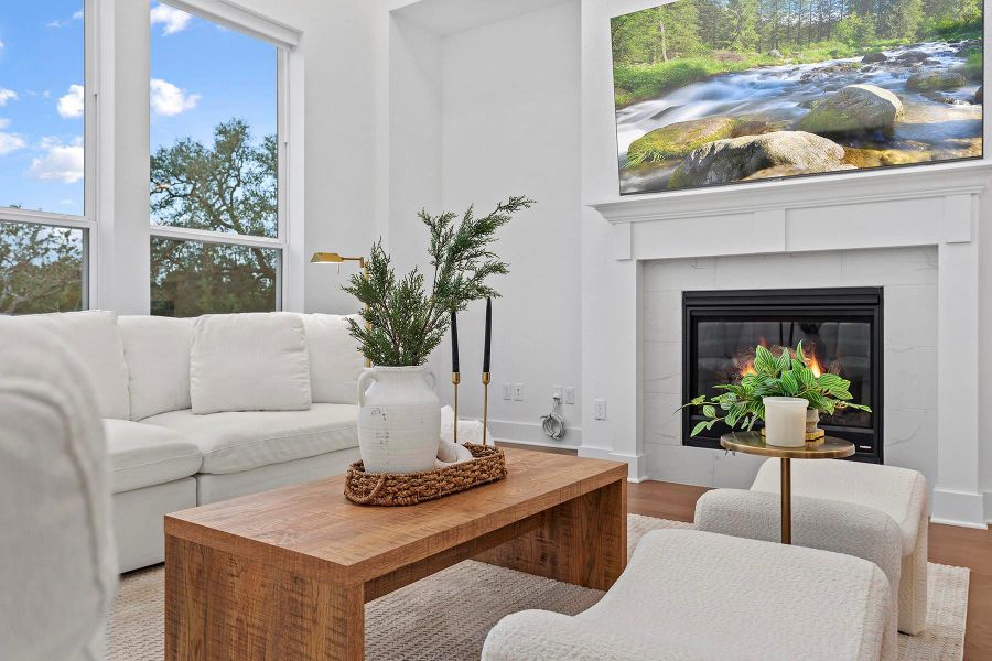 Living room featuring a tiled fireplace and hardwood / wood-style floors