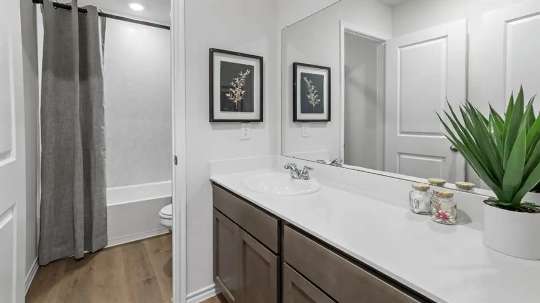 Bathroom vanity featuring an integrated sink, polished chrome faucet, and expansive countertop