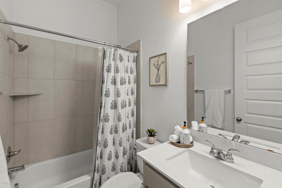 Clean lines and modern tile surround define this functional second bathroom.