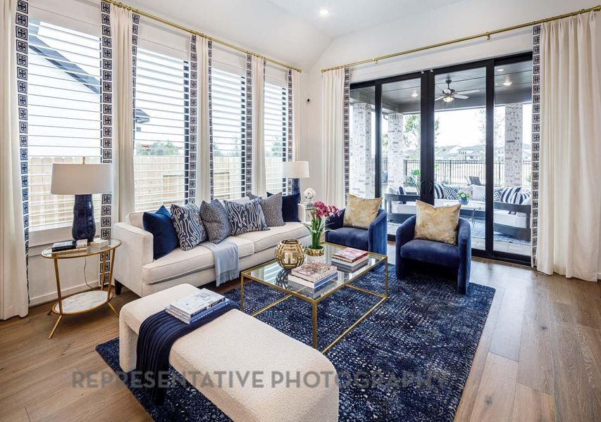 Living area with wood finished floors, vaulted ceiling, ceiling fan, and recessed lighting Living area with wood finished floors, vaulted ceiling, ceiling fan, and recessed lighting