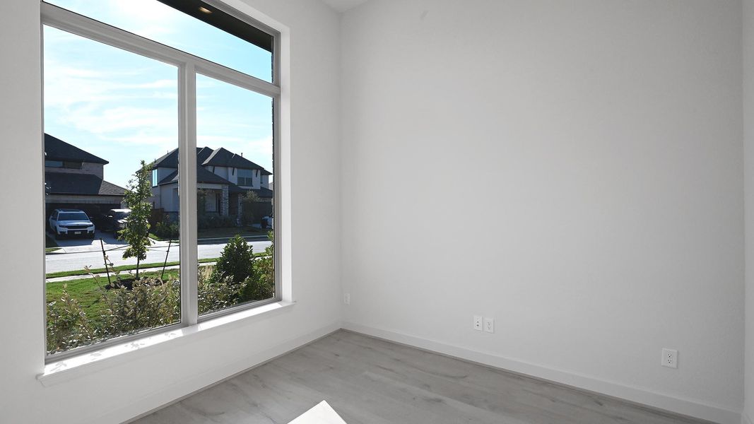Unfurnished room featuring baseboards and wood finished floors Unfurnished room featuring baseboards and wood finished floors