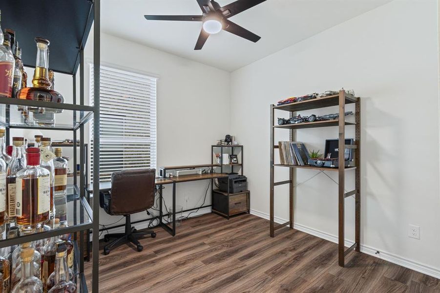 Secondary bedroom being utilized as an office.. LVP flooring & upgraded ceiling fan!