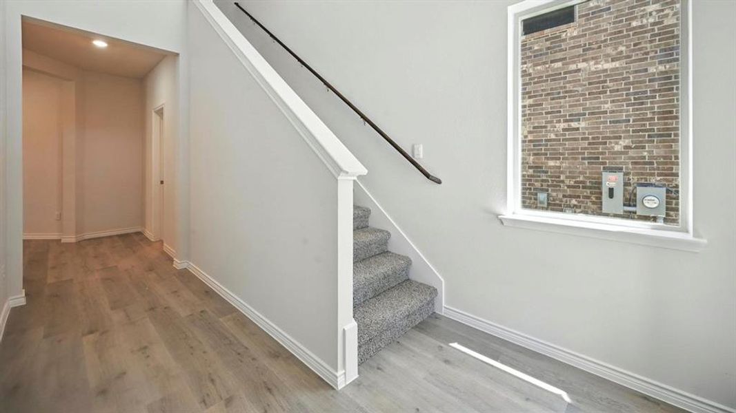 Stairway featuring wood finished floors