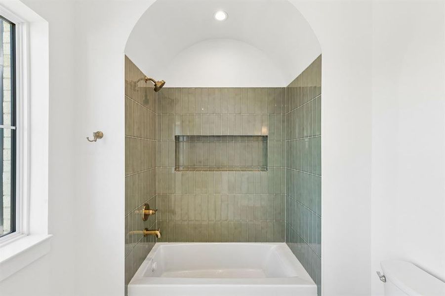 Bathroom featuring toilet and bathing tub / shower combination