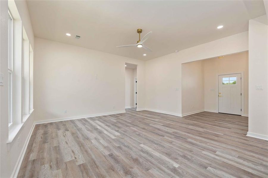 Unfurnished room featuring a ceiling fan, light wood finished floors, and recessed lighting Unfurnished room featuring a ceiling fan, light wood finished floors, and recessed lighting