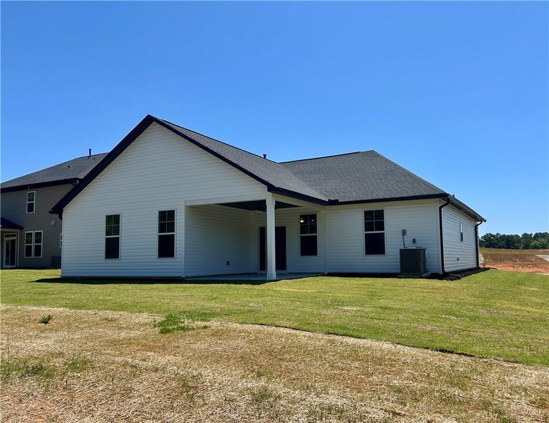 This newly constructed home features a covered pat