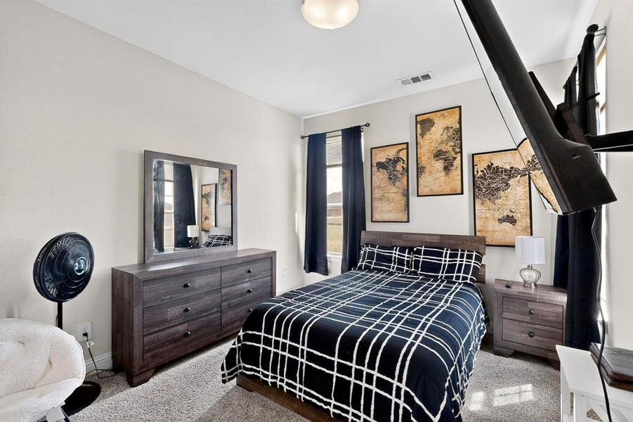 Carpeted bedroom featuring baseboards Carpeted bedroom featuring baseboards