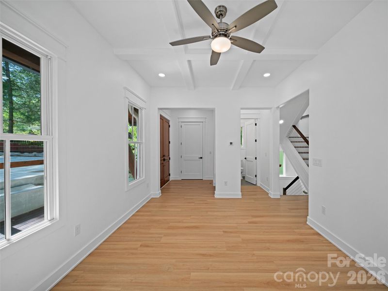 Main entrance foyer with door to half bath and main staircase.