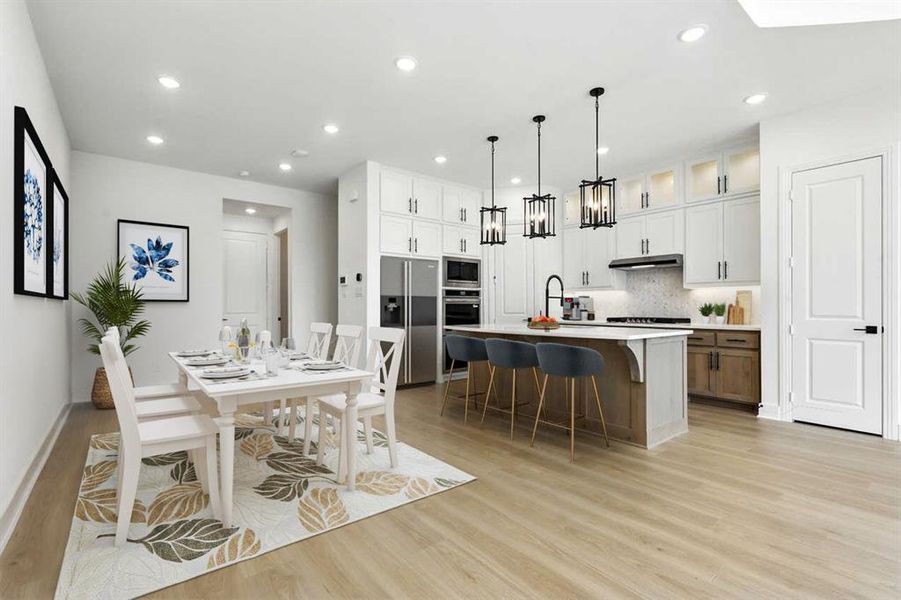 Dining space with light wood-style flooring and recessed lighting Dining space with light wood-style flooring and recessed lighting
