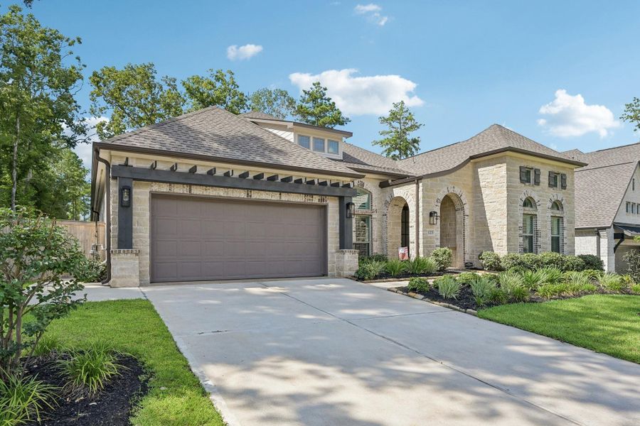 Front exterior of a new home in The Woodlands Hills, Willis, TX, highlighting curb appeal (Image 24).
