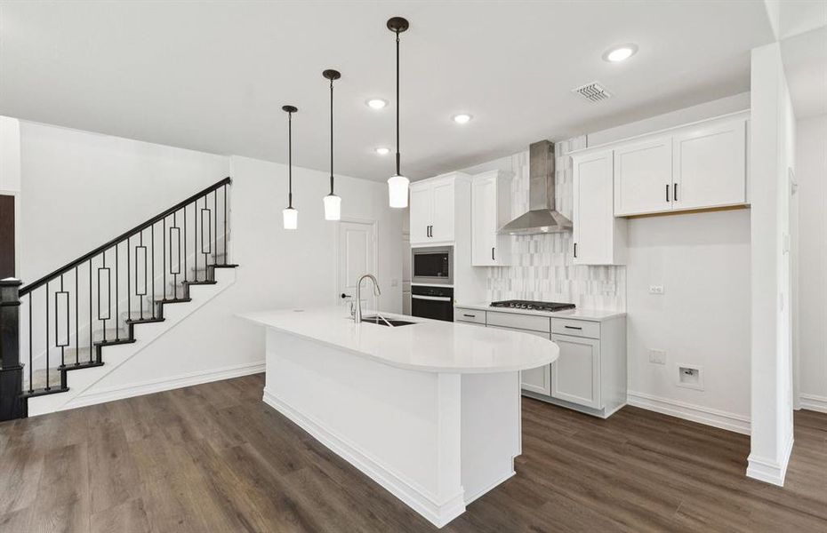 High-end gourmet kitchen with premium finishes and upgraded appliances   *Real home pictured