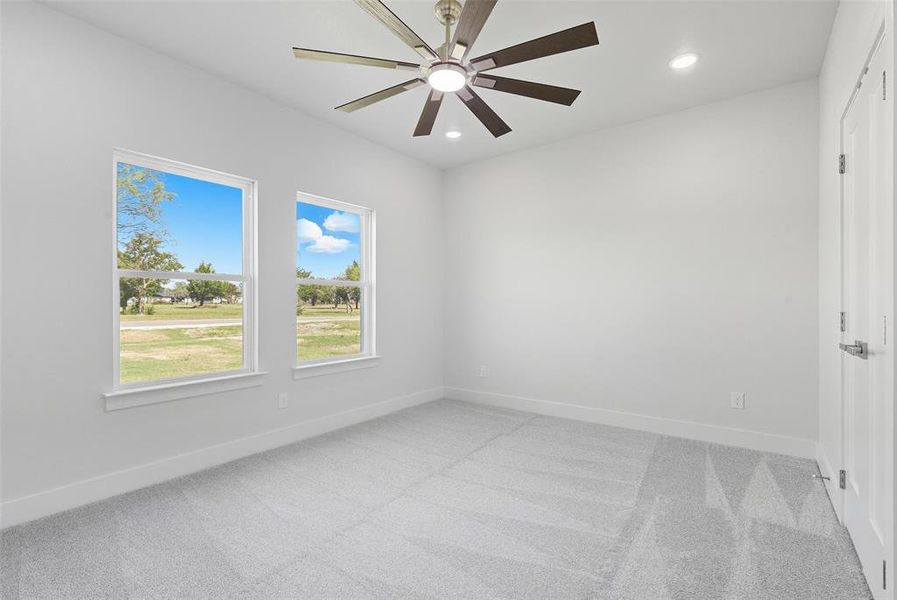 Empty room featuring light carpet, recessed lighting, and a ceiling fan Empty room featuring light carpet, recessed lighting, and a ceiling fan