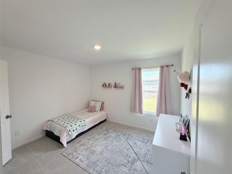 Bright and spacious secondary bedroom features its own walk-in closet for maximum storage and organization. Bright and spacious secondary bedroom features its own walk-in closet for maximum storage and organization.