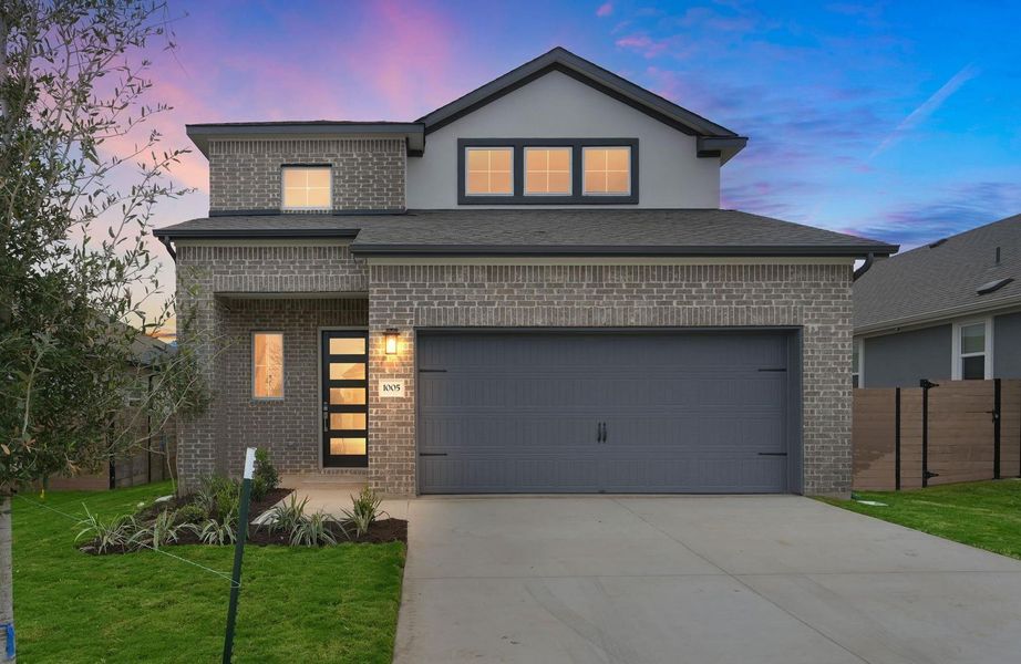 View of front of house featuring brick siding, driveway, a garage, a shingled roof, and stucco siding