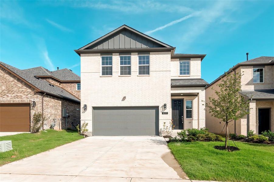 View of front of house featuring brick siding, board and batten siding, an attached garage, a front lawn, and driveway View of front of house featuring brick siding, board and batten siding, an attached garage, a front lawn, and driveway