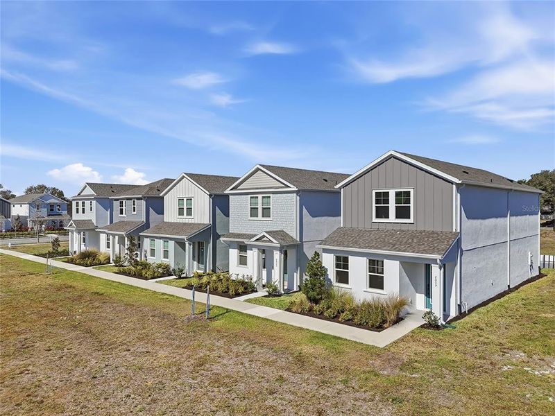 Front exterior of a new home in Vivir, Valrico, FL, highlighting curb appeal (Image 27).