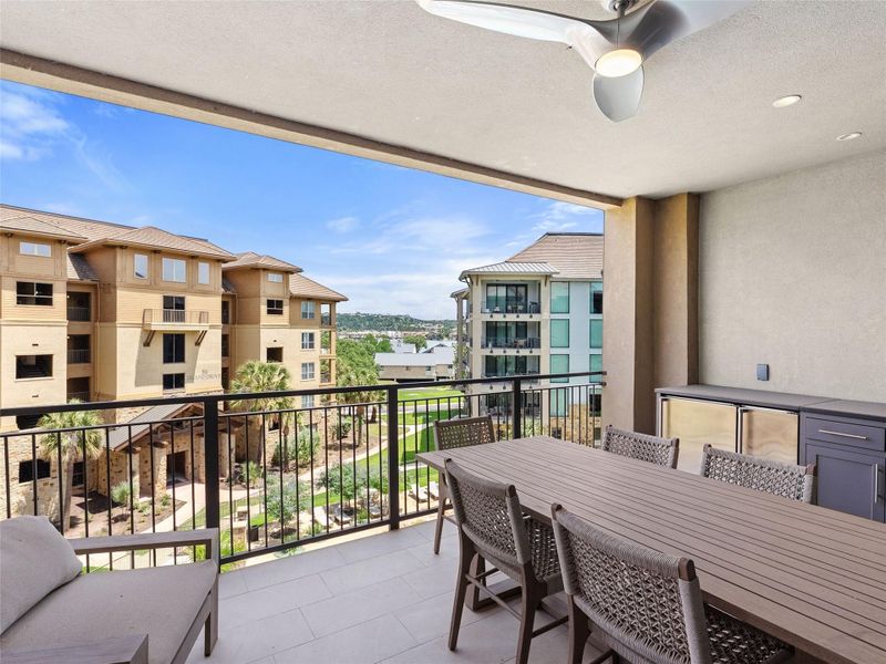 Expansive outdoor patio with ceiling fan, recessed lighting, and integrated beverage refrigerators, icemaker and sink. Expansive outdoor patio with ceiling fan, recessed lighting, and integrated beverage refrigerators, icemaker and sink.