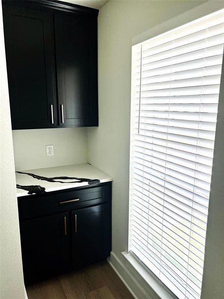 Bar featuring dark wood-style floors and healthy amount of natural light Bar featuring dark wood-style floors and healthy amount of natural light