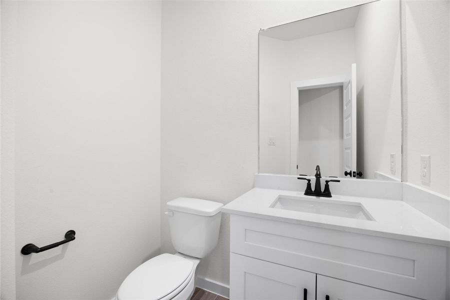 Powder room located right off the family room Powder room located right off the family room