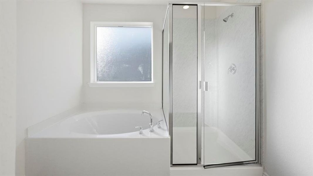 Full bath featuring a garden tub and a stall shower