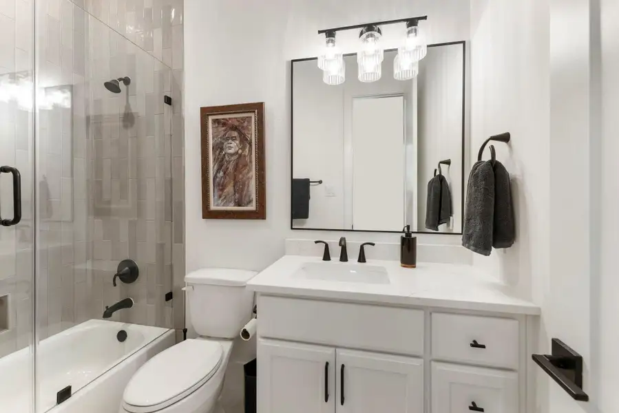 4th full bathroom continues the home’s upgraded finish level with tile carried to the ceiling. The design feels fresh, intentional, and well suited for guests or everyday use.