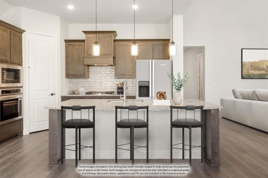 Kitchen with large island, three bar stools, granite countertops, wood cabinets, and stainless steel appliances Kitchen with large island, three bar stools, granite countertops, wood cabinets, and stainless steel appliances